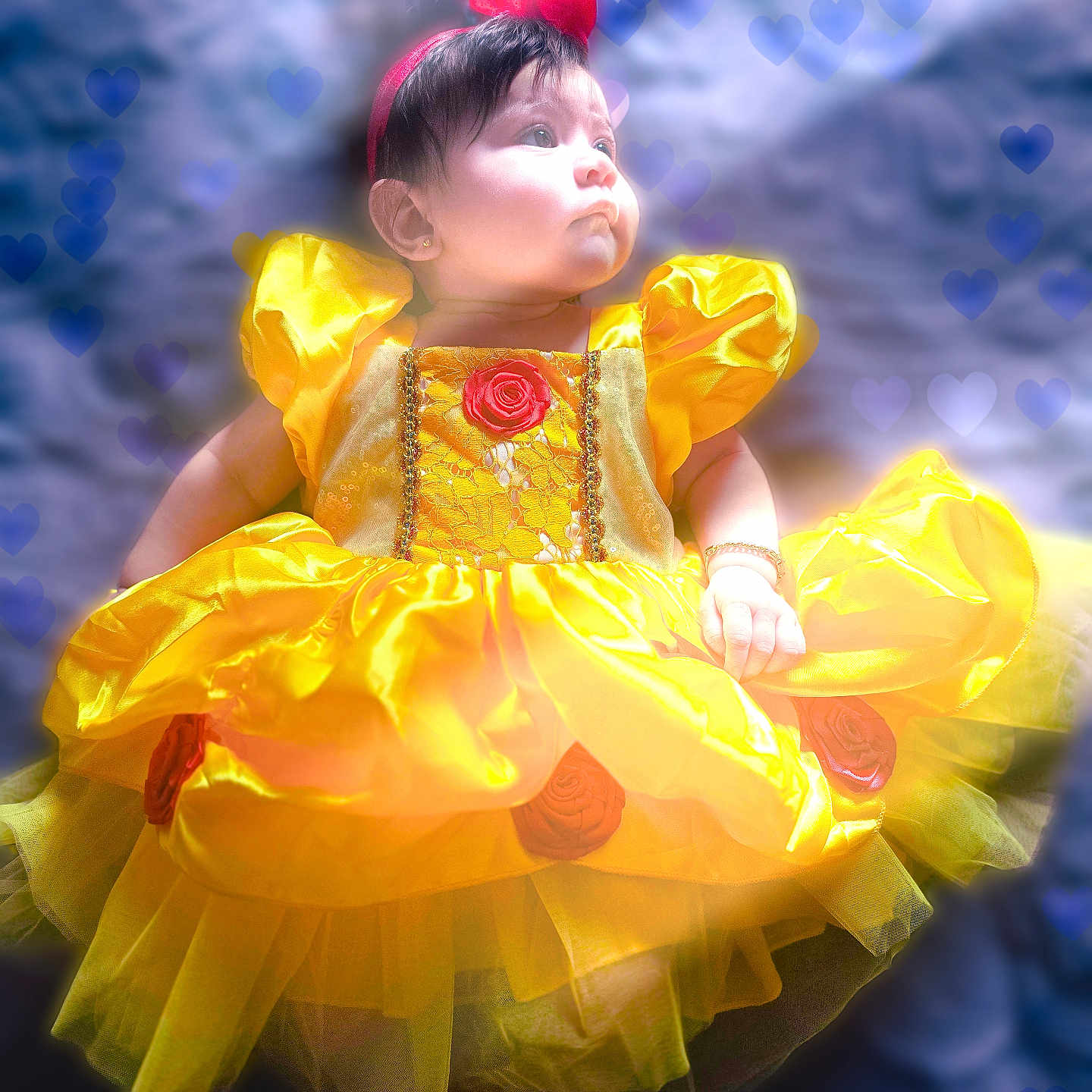 Jeannine is registered to the contest to win money with this photo: adorable, baby, blue_background, bracelet, child, costume, cute, dress, earrings, fabric, face, heart_overlay, infant, lying_down, portrait, puffed_sleeves, red_headband, soft_lighting, tulle_skirt, yellow_dress