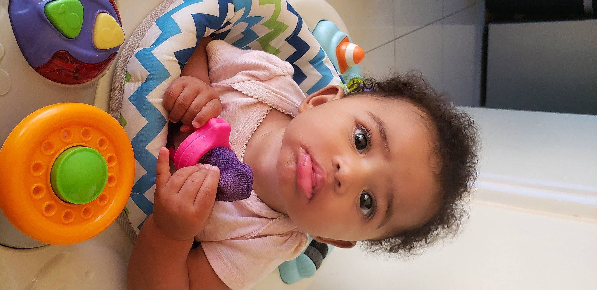 Crayton is registered to the contest to win money with this photo: arm, baby_playing_with_toys, cheek, child, eye, eyelash, facial_expression, fun, happy, headgear, human_body, iris, lip, mouth, nose, person, skin, smile, textile, toddler