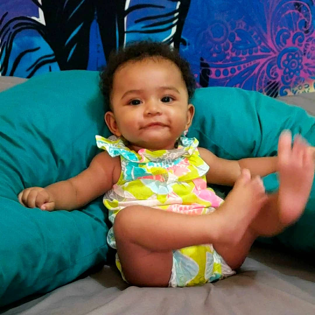 Crayton is registered to the contest to win money with this photo: aqua, baby, baby_toddler_clothing, cheek, comfort, dress, eye, face, facial_expression, finger, fun, hairstyle, happy, head, human_body, lap, person, pink, skin, textile