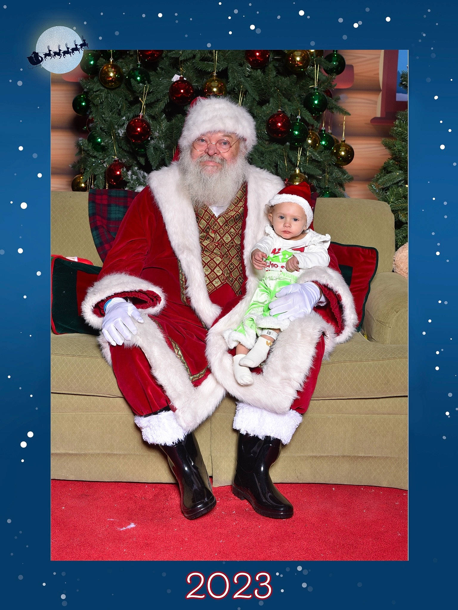 Ireland is registered to the contest to win money with this photo: baby, beard, christmas, christmas_decoration, christmas_eve, christmas_tree, event, facial_hair, fictional_character, greeting, happy, headwear, holiday, interior_design, lap, person, red, santa_claus, sleeve, smile