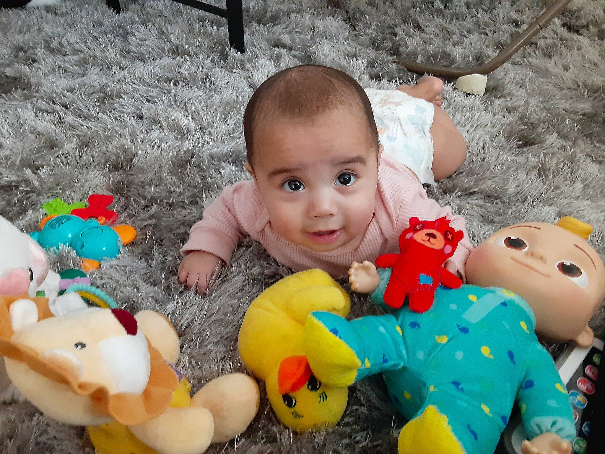 Briana is registered to the contest to win money with this photo: adaptation, baby, baby_toddler_clothing, cheek, eye, fun, grass, happy, head, organ, person, photograph, product, red, skin, smile, textile, toddler, toy, white