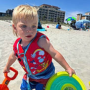 Sawyer joined the competition — help win amazing prizes! child, toddler, beach, sand, shovel, frisbee, life_vest, sunny, blue_sky, shorts, barefoot, toy, outdoor, vacation, summer, building_sandcastles, playing, colorful, water_toys, daytime
