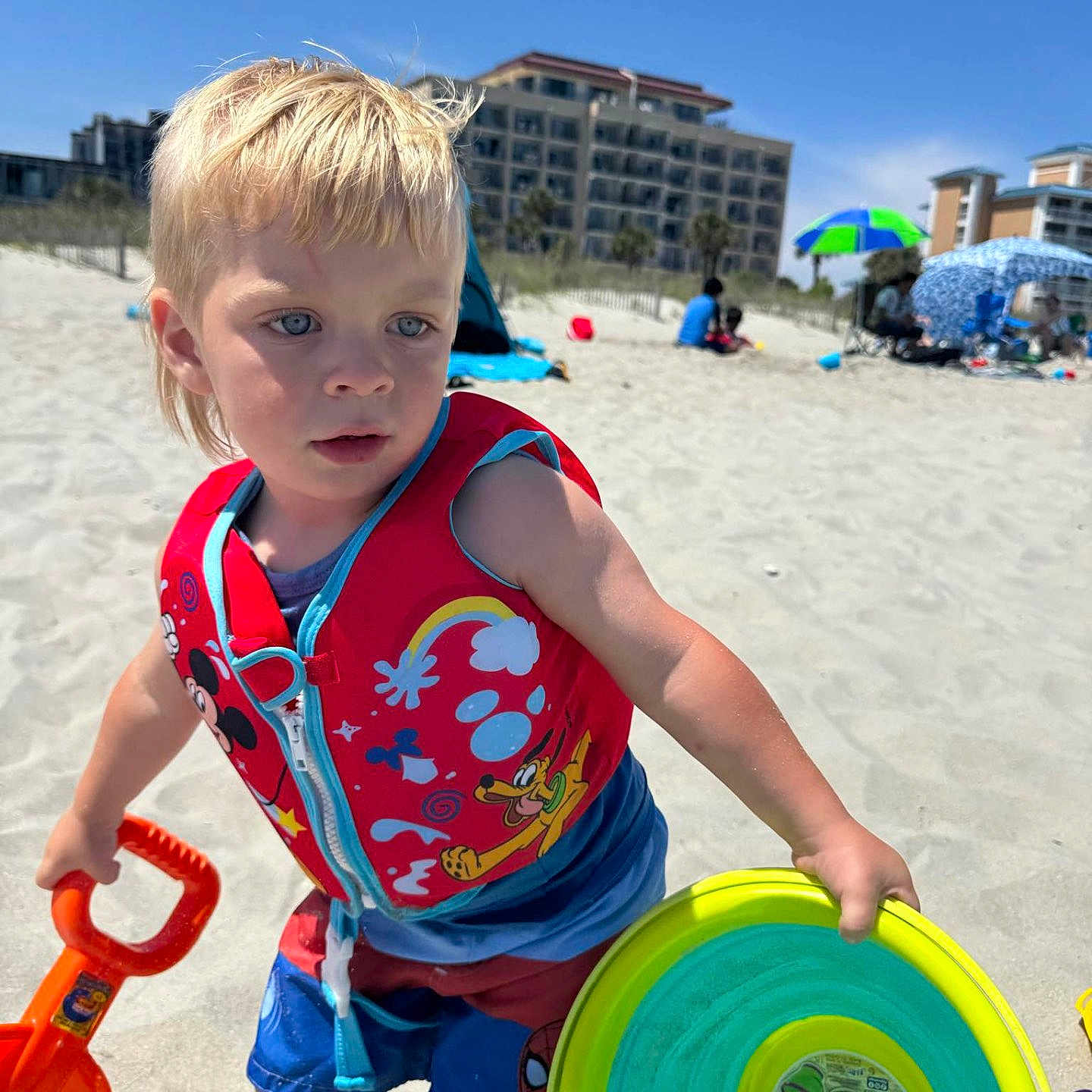 Sawyer joined the competition — help win amazing prizes! barefoot, beach, blue_sky, building_sandcastles, child, colorful, daytime, frisbee, life_vest, outdoor, playing, sand, shorts, shovel, summer, sunny, toddler, toy, vacation, water_toys