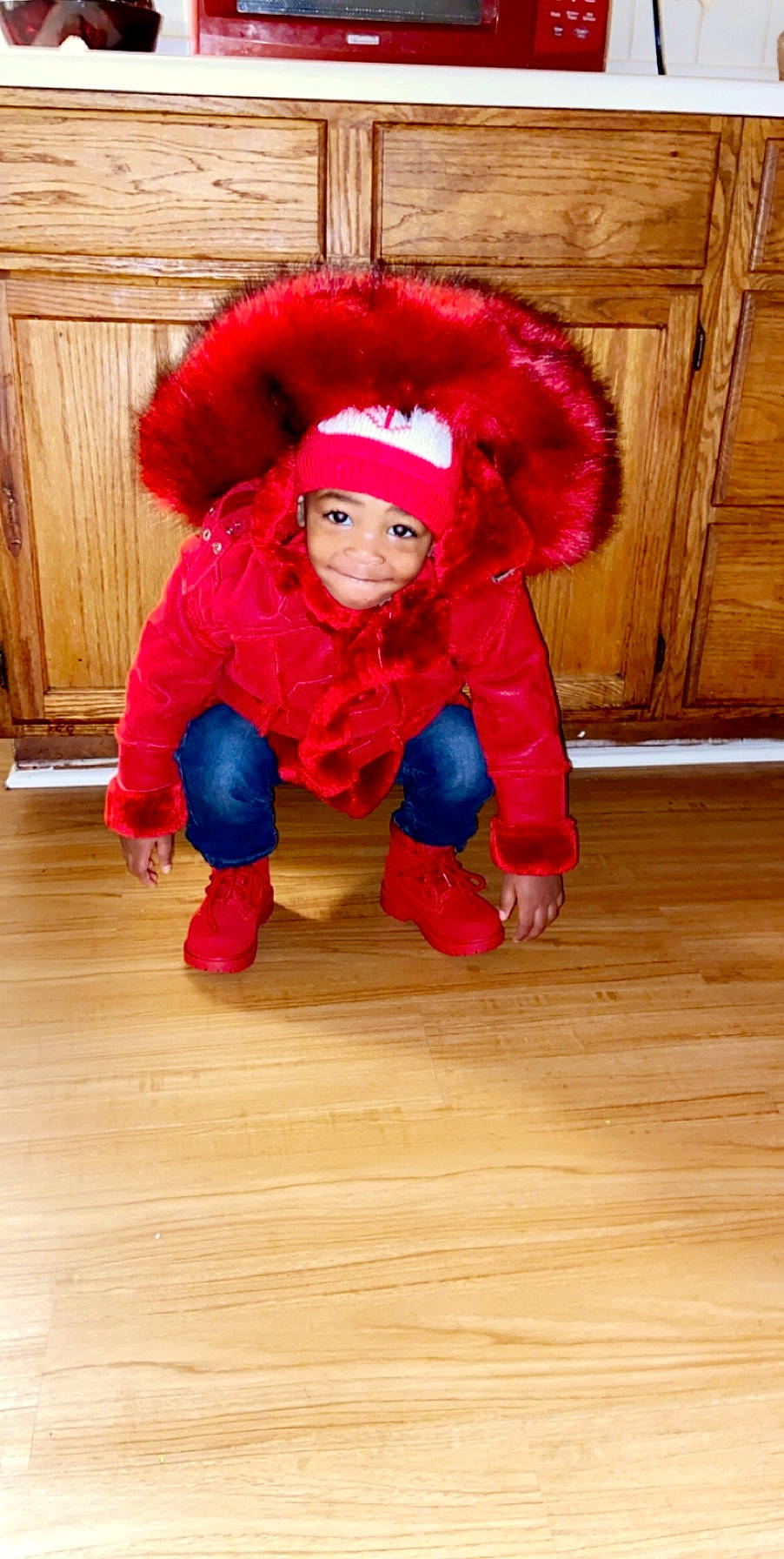 Davion is registered to the contest to win money with this photo: child, costume, fictional_character, fur, headwear, joy, outerwear, person, play, red, toddler, wood