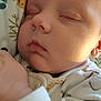 Elyjah is registered to the contest to win money with this photo: baby, sleeping, infant, face, hand, onesie, animal_prints, cozy, soft_light, closeup, peaceful, child, cute, newborn, skin, pajamas, indoors, resting, calm, portrait