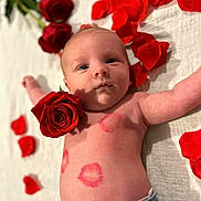 Andréa participe au concours pour gagner de l'argent avec cette photo : baby, infant, newborn, rose, rose_petals, flower, petals, kiss_marks, lipstick, bed, blanket, denim, jeans, shirtless, portrait, closeup, lying_down, face, eyes_open, rosy_cheeks