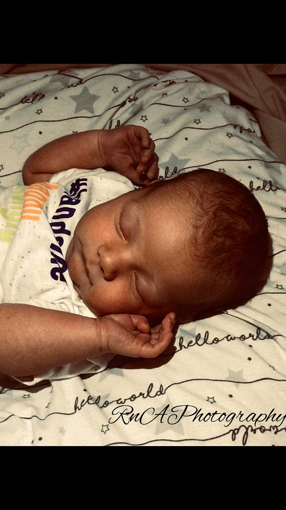 Maverick is registered to the contest to win money with this photo: abdomen, adaptation, art, baby, barechested, bedtime, chest, child, comfort, eyebrow, face, flesh, font, forehead, handwriting, happy, head, pattern, person, photo_caption