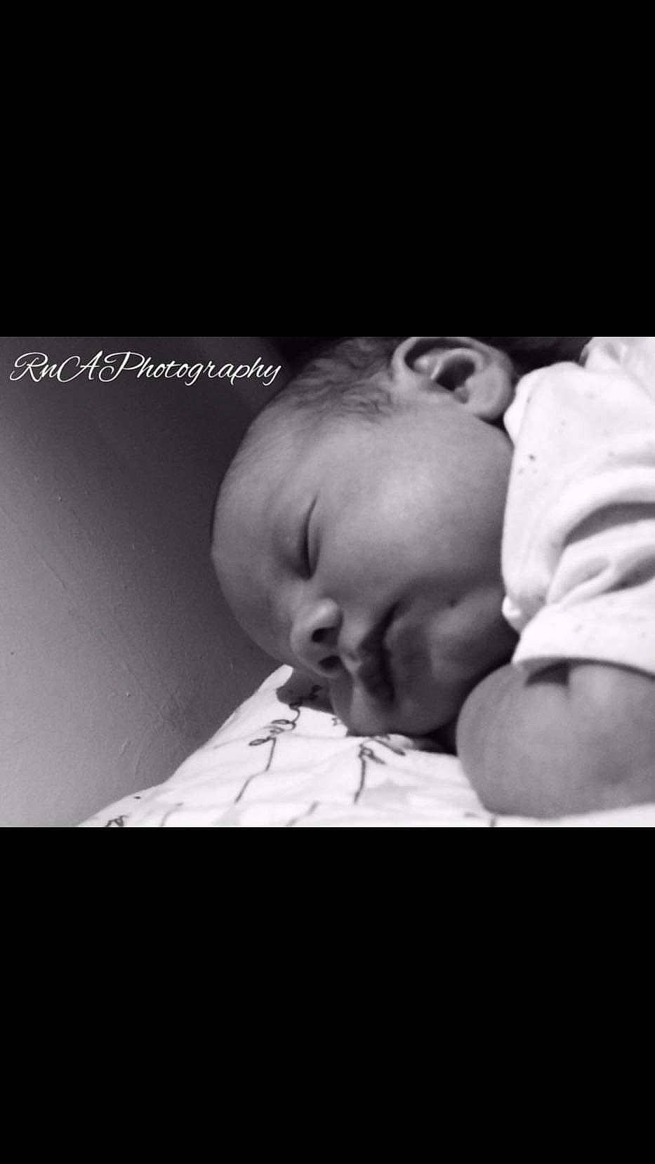 Maverick is registered to the contest to win money with this photo: baby, baby_toddler_clothing, bedtime, cheek, child, comfort, darkness, facial_expression, flash_photography, font, happy, human_body, monochrome, monochrome_photography, mouth, person, sitting, skin, smile, toddler
