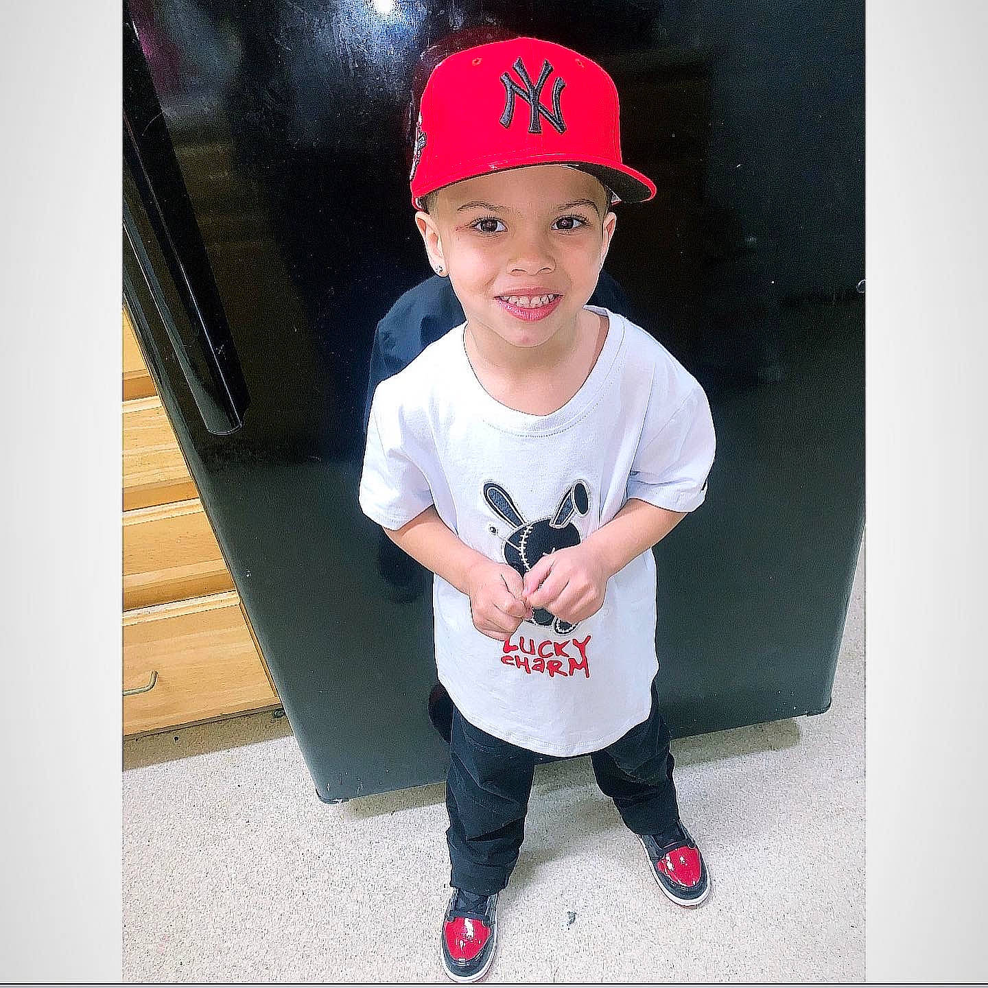 Nasiah is registered to the contest to win money with this photo: baby_toddler_clothing, baseball_cap, cap, child, costume_hat, cricket_cap, electric_blue, eyewear, face, fashion_accessory, flash_photography, footwear, happy, head, headwear, joy, pattern, person, sleeve, smile