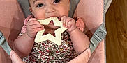 Juliette joined the competition — help win amazing prizes! baby, infant, teething_toy, star_shaped_toy, baby_chair, pink_chair, gray_chair, floral_clothing, cute, chubby_cheeks, indoors, wooden_floor, hand, legs, face, eyes, mouth, sitting, child, comfort