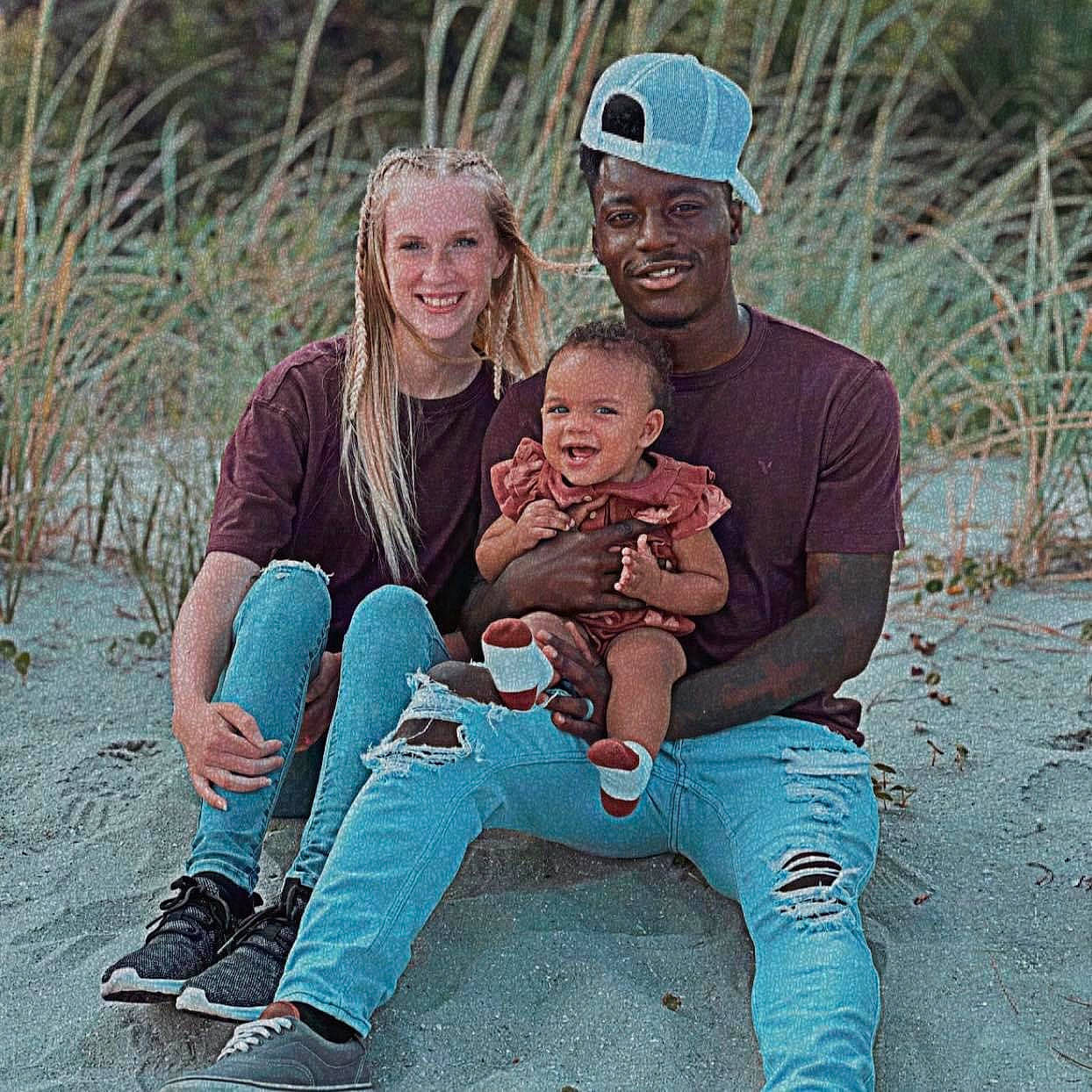 Royalty is registered to the contest to win money with this photo: baby, boot, cap, child, event, face, flash_photography, fun, grass, happy, hat, headwear, jeans, joy, lap, laugh, leisure, people_in_nature, person, sitting