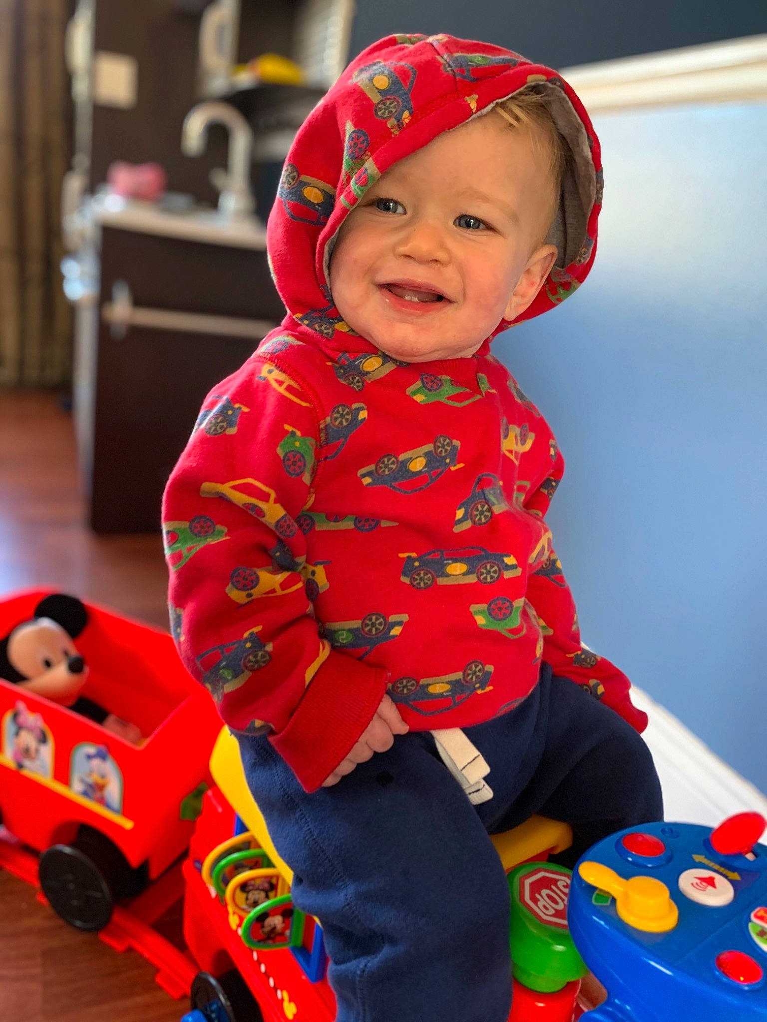 Finnegan joined the competition — help win amazing prizes! baby, baby_products, baby_toddler_clothing, cheek, child, fictional_character, hoodie, joy, outerwear, person, play, product, red, skin, sleeve, smile, toddler, toy, vehicle, yellow