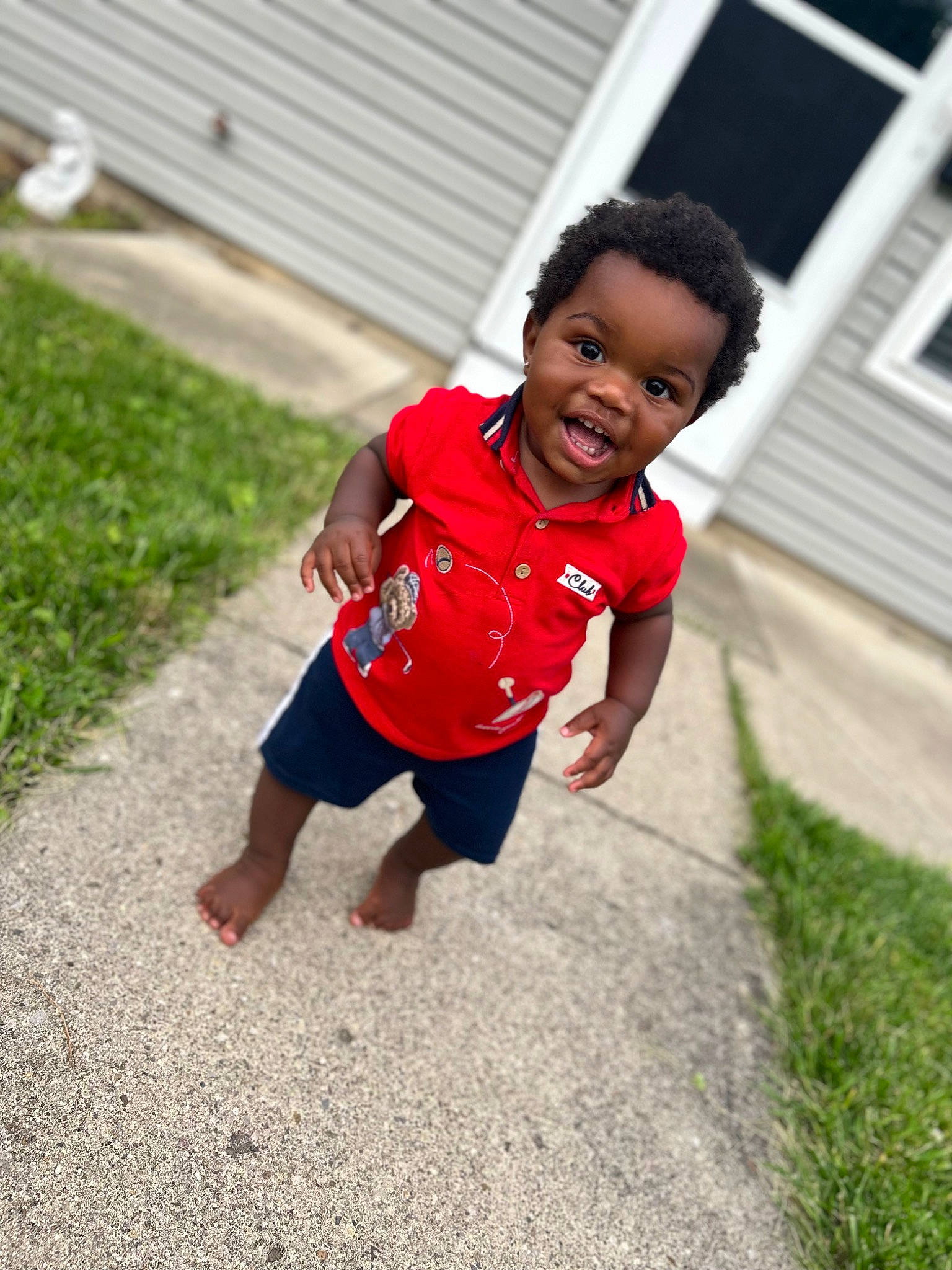Messiah is registered to the contest to win money with this photo: asphalt, baby, baby_toddler_clothing, child, flooring, fun, grass, happy, lawn, leg, leisure, people_in_nature, person, plant, recreation, shorts, smile, t_shirt, toddler, tree
