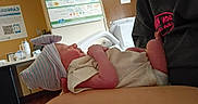 Raelynn is registered to the contest to win money with this photo: arms, baby, bedroom, care, clothing, cradle, cute, hat, healthcare, hospital, human, indoor, infant, medical, newborn, patient, person, resting, sleeping, small