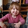 casual, child, couch, cozy, face, fan, furniture, hair, hand, happy, home, indoor, pattern, person, pink_clothing, portrait, shelf, smile, toddler, young_child