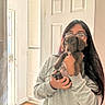 Cami joined the competition — help win amazing prizes! woman, puppy, dog, pet, portrait, mirror_selfie, indoors, bathroom, long_hair, glasses, hoodie, brown_dog, floppy_ears, holding_pet, candid, home, doorway, sink, cup, happy