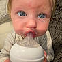 Rose is registered to the contest to win money with this photo: baby, bottle, blue_eyes, child, couch, face, feeding, hand, infant, mouth, nipple, person, plush, portrait, sitting, skin, texture, young, closeup, indoor
