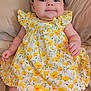 Florence joined the competition — help win amazing prizes! baby, bed, blanket, blue_eyes, child, cute, dress, fabric, floral_pattern, hair, hand, indoors, infant, legs, lying_down, portrait, skin, smile, soft, yellow_flowers