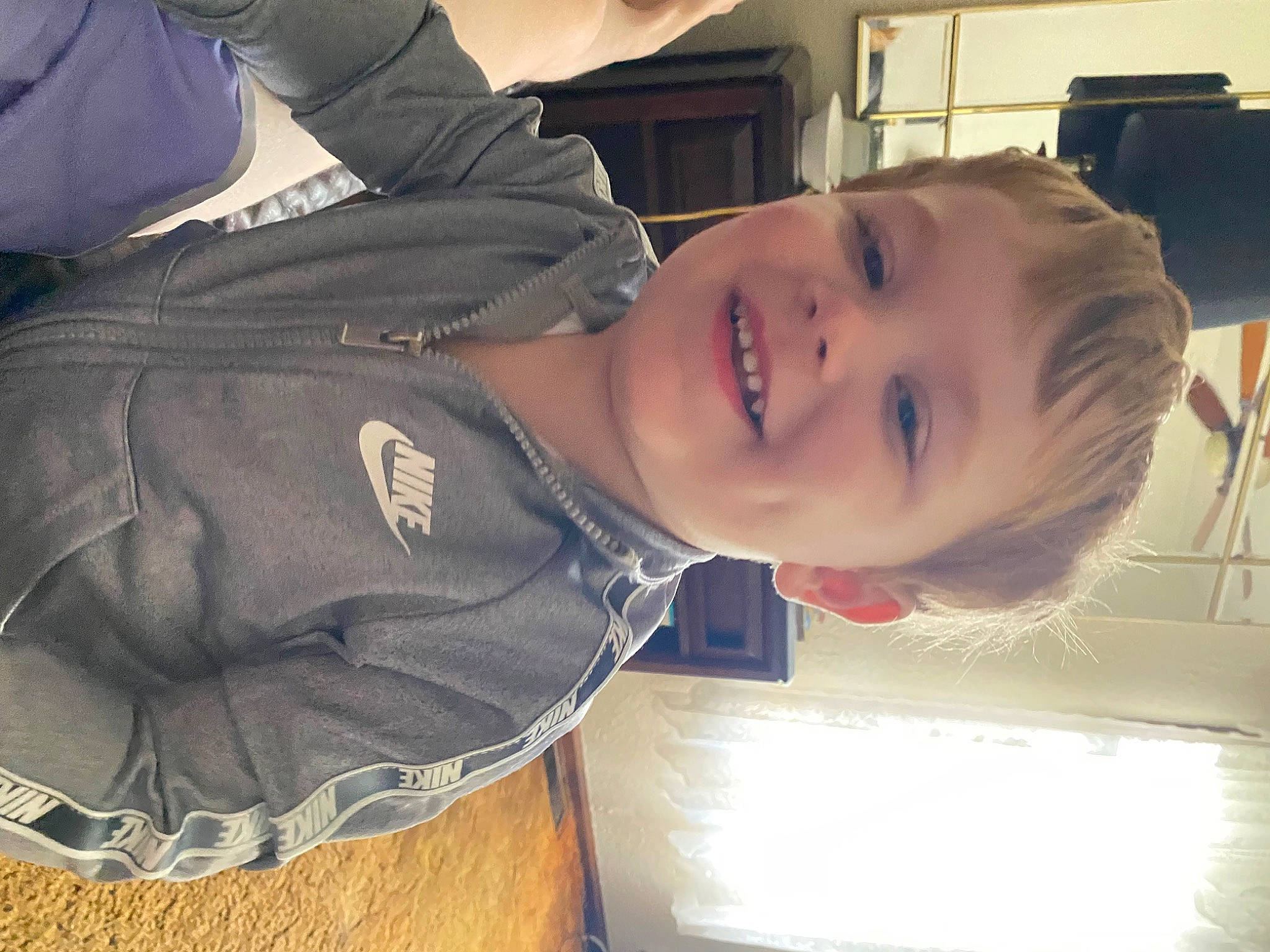 Callen is registered to the contest to win money with this photo: baby, cheek, child, chin, comfort, elbow, fun, happy, joy, laugh, mouth, nose, person, room, sitting, sleeve, smile, toddler, wood