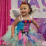 Ileanna joined the competition — help win amazing prizes! toddler, child, smiling, dress, fairy_wings, flower_crown, colorful, costume, happy, indoor, curtain, banner, celebration, playful, portrait, event, stage, cute, girl, motion