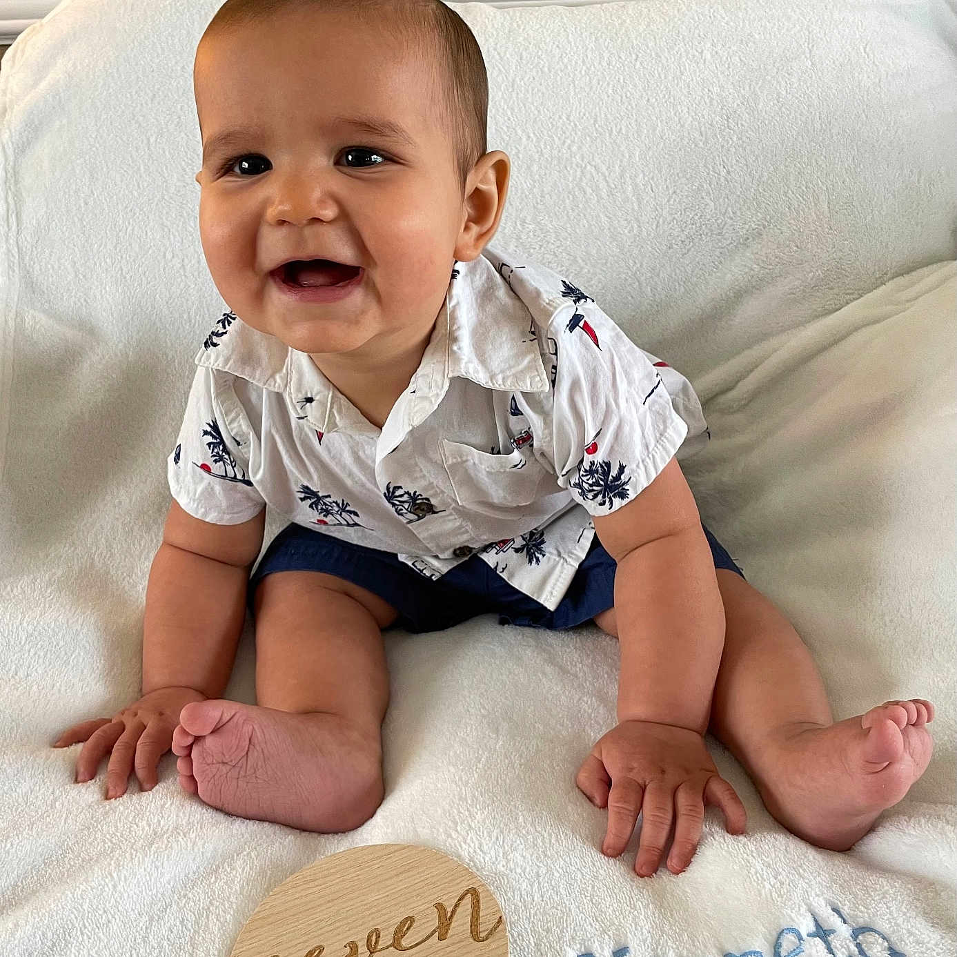 Kenneth is registered to the contest to win money with this photo: baby, babylaughing, clothing, crawling, cushion, face, happy, head, homedecor, person, photography, portrait, shorts, sitting, sleeve, smile, text