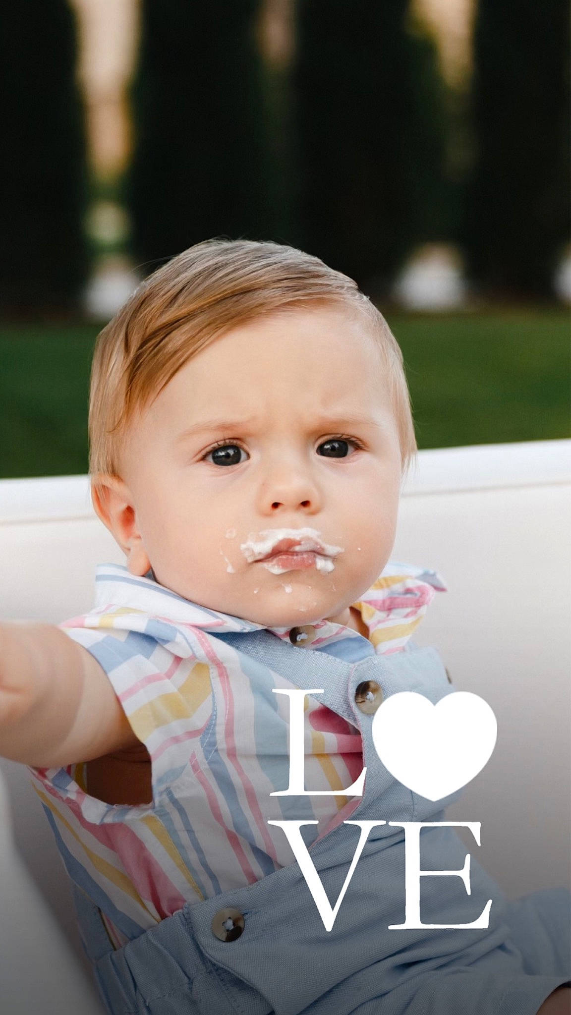 Theodore is registered to the contest to win money with this photo: baby, baby_toddler_clothing, cheek, child, flash_photography, fun, grass, happy, leisure, logo, person, photo_caption, portrait_photography, recreation, sitting, skin, sleeve, t_shirt, toddler