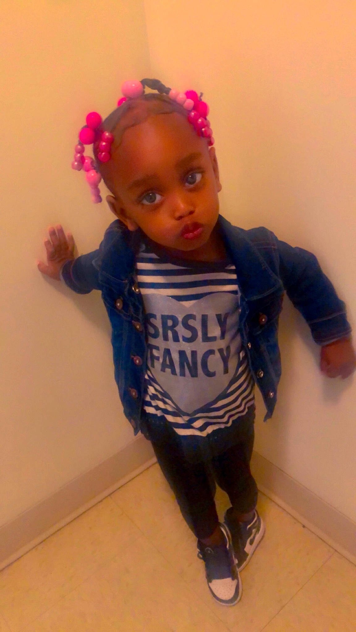 Janiya is registered to the contest to win money with this photo: baby, baby_products, baby_toddler_clothing, black_hair, cheek, electric_blue, eyebrow, fashion_accessory, headband, headpiece, iris, jewellery, leg, person, personal_protective_equipment, sleeve, standing, t_shirt, toddler, trunk