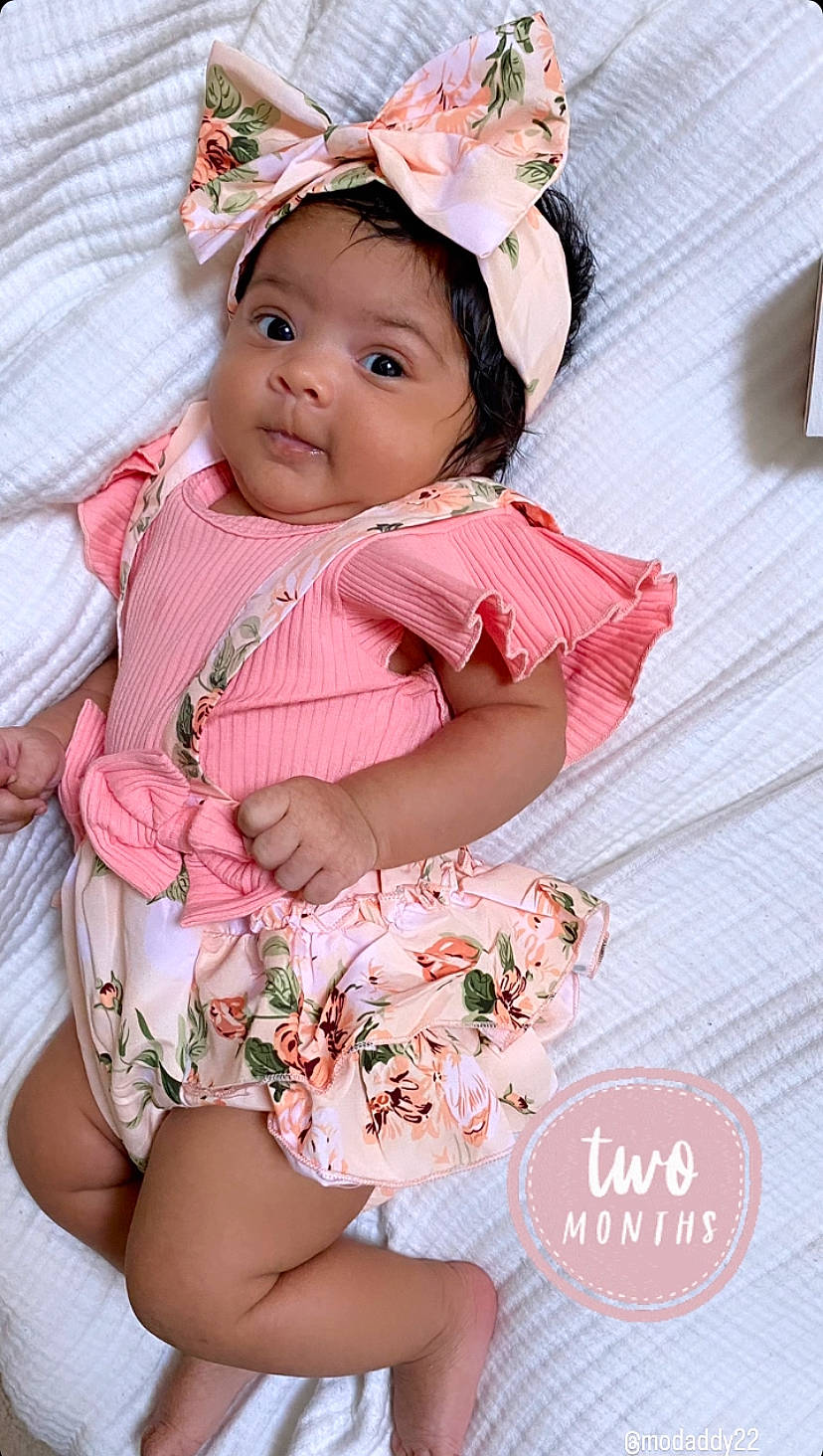 Ariana joined the competition — help win amazing prizes! baby, baby_toddler_clothing, child, day_dress, dress, embellishment, event, face, happy, headpiece, headwear, magenta, pattern, peach, person, petal, photograph, pink, skin, sleeve