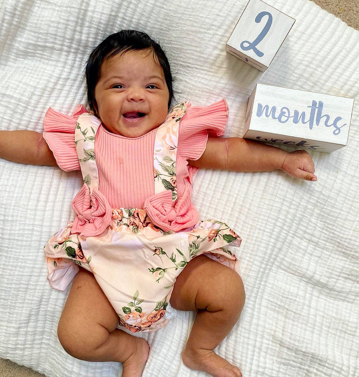 Ariana is registered to the contest to win money with this photo: baby, baby_toddler_clothing, cheek, comfort, face, finger, fun, gesture, happy, human_body, leg, neck, person, pink, skin, sleeve, smile, textile, thigh, thumb