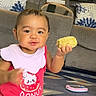 Anastasia joined the competition — help win amazing prizes! toddler, child, corn_on_the_cob, bib, red_shirt, carpet, living_room, sofa, cushion, toy, playful, smile, baby, indoor, furniture, cute, hand, person, floor, casual