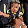 Waverly is registered to the contest to win money with this photo: baby, smiling, car_seat, child, headband, leopard_print, hand, adult_hand, clothing, seatbelt, infant, cute, portrait, happy, person, sitting, indoor, bonding, toddler, bright