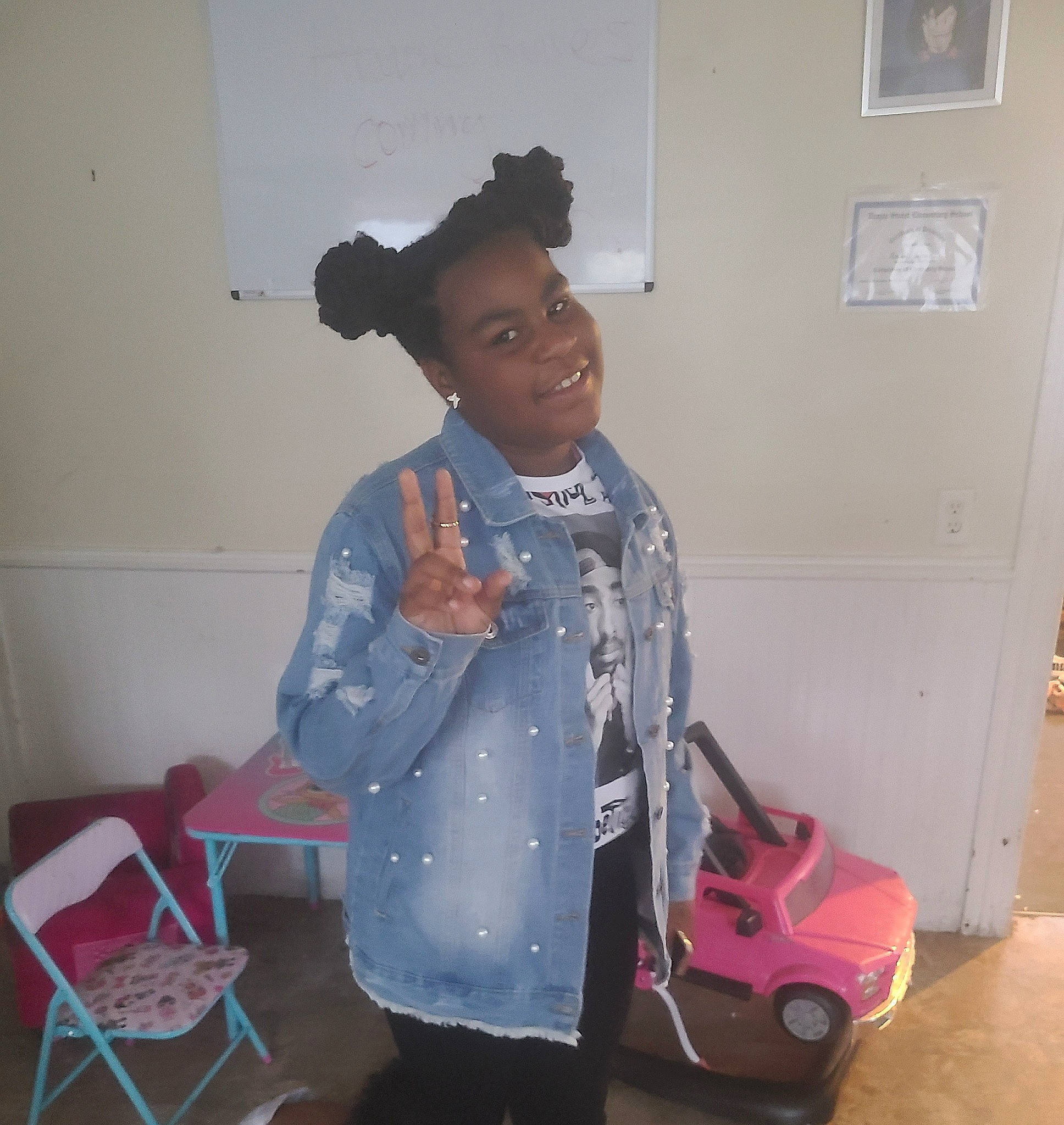 Amani is registered to the contest to win money with this photo: baby_products, baby_toddler_clothing, baby_toys, bag, chair, child, flooring, fun, happy, joy, pattern, person, room, sitting, sleeve, smile, standing, t_shirt, toddler, toy