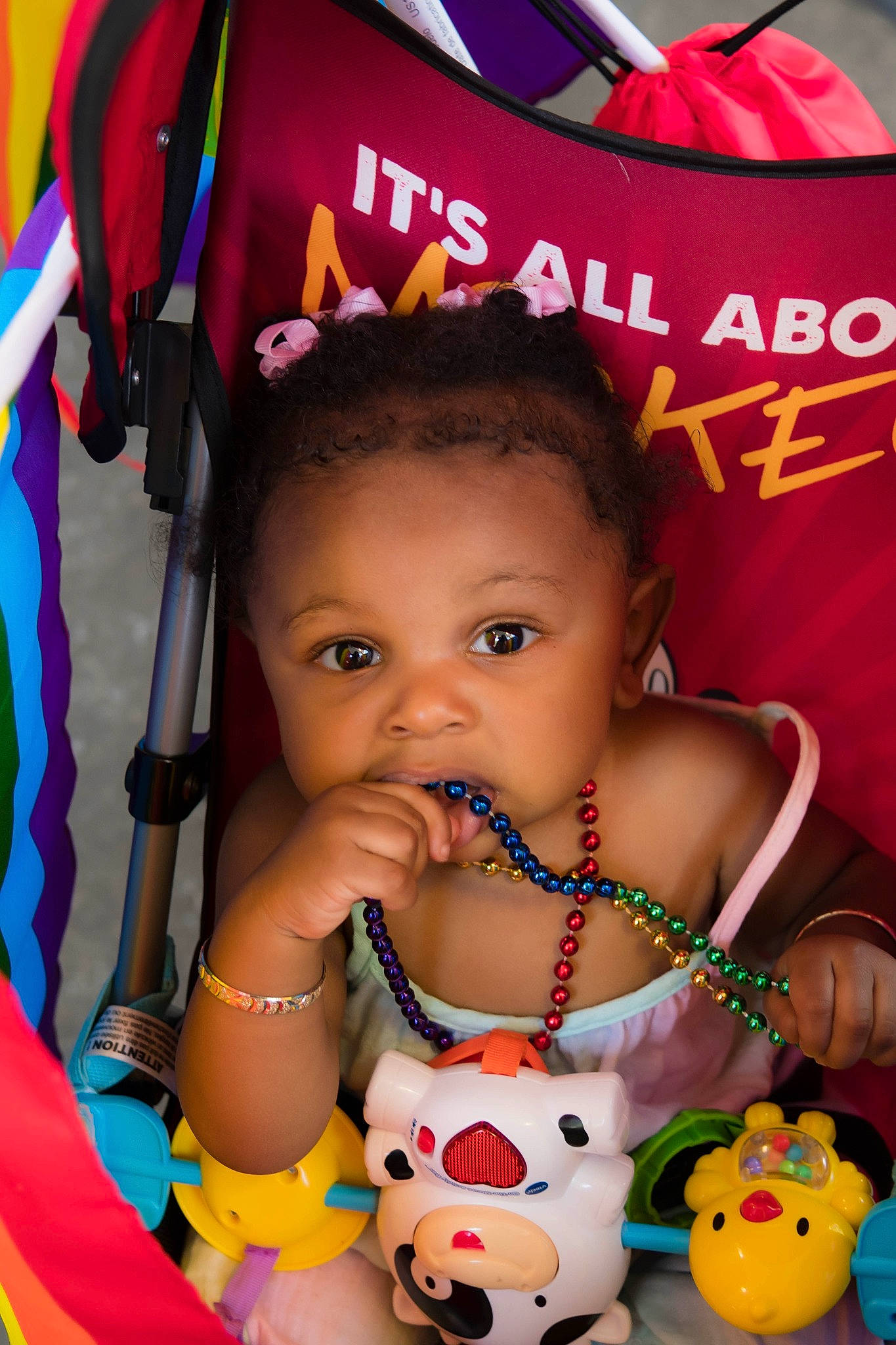 Arlee is registered to the contest to win money with this photo: beauty, black, child, face, facial_expression, fun, green, happy, head, human, orange, organ, person, pink, product, red, skin, toddler, toy, white