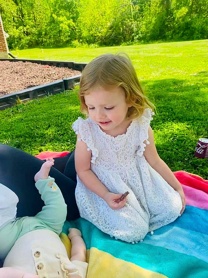 Braelynn is registered to the contest to win money with this photo: baby, baby_toddler_clothing, child, event, fun, grass, green, happy, lap, lawn, leisure, people_in_nature, person, pink, plant, recreation, sitting, summer, thigh, toddler