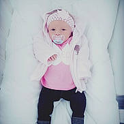 Emmy participe au concours pour gagner de l'argent avec cette photo : child, costume, eye, fun, girl, hair_accessory, human_hair_color, infant, material, photograph, pink, product, purple, skin, smile, textile, toddler, white, winter