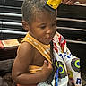 Kyrie joined the competition — help win amazing prizes! child, haircut, barbershop, clippers, cape, colorful, pattern, toy_truck, yellow, person, hair, close_up, interior, seat, hand, grooming, focused, young, boy, indoors