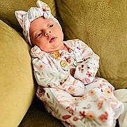 Vyvienne joined the competition — help win amazing prizes! baby, infant, child, onesie, headband, floral_pattern, couch, sofa, fabric, buttons, soft_toys, comfort, relaxing, indoors, portrait, cute, peaceful, clothing, person, young
