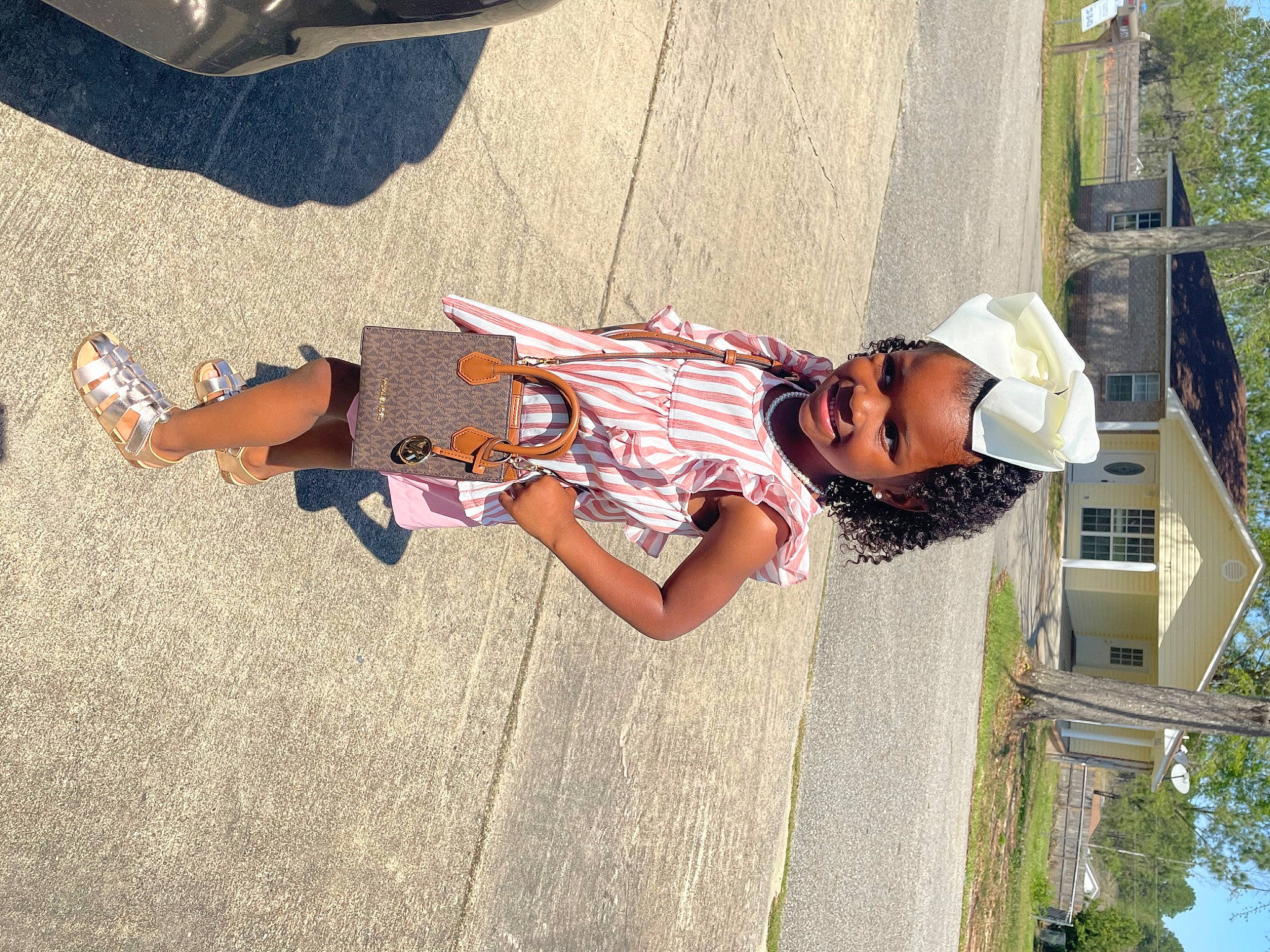 Braylee is registered to the contest to win money with this photo: asphalt, city, eyewear, fun, happy, hat, human_leg, joy, leisure, person, plant, recreation, road_surface, shadow, shoe, sidewalk, toddler, travel, tree, vacation