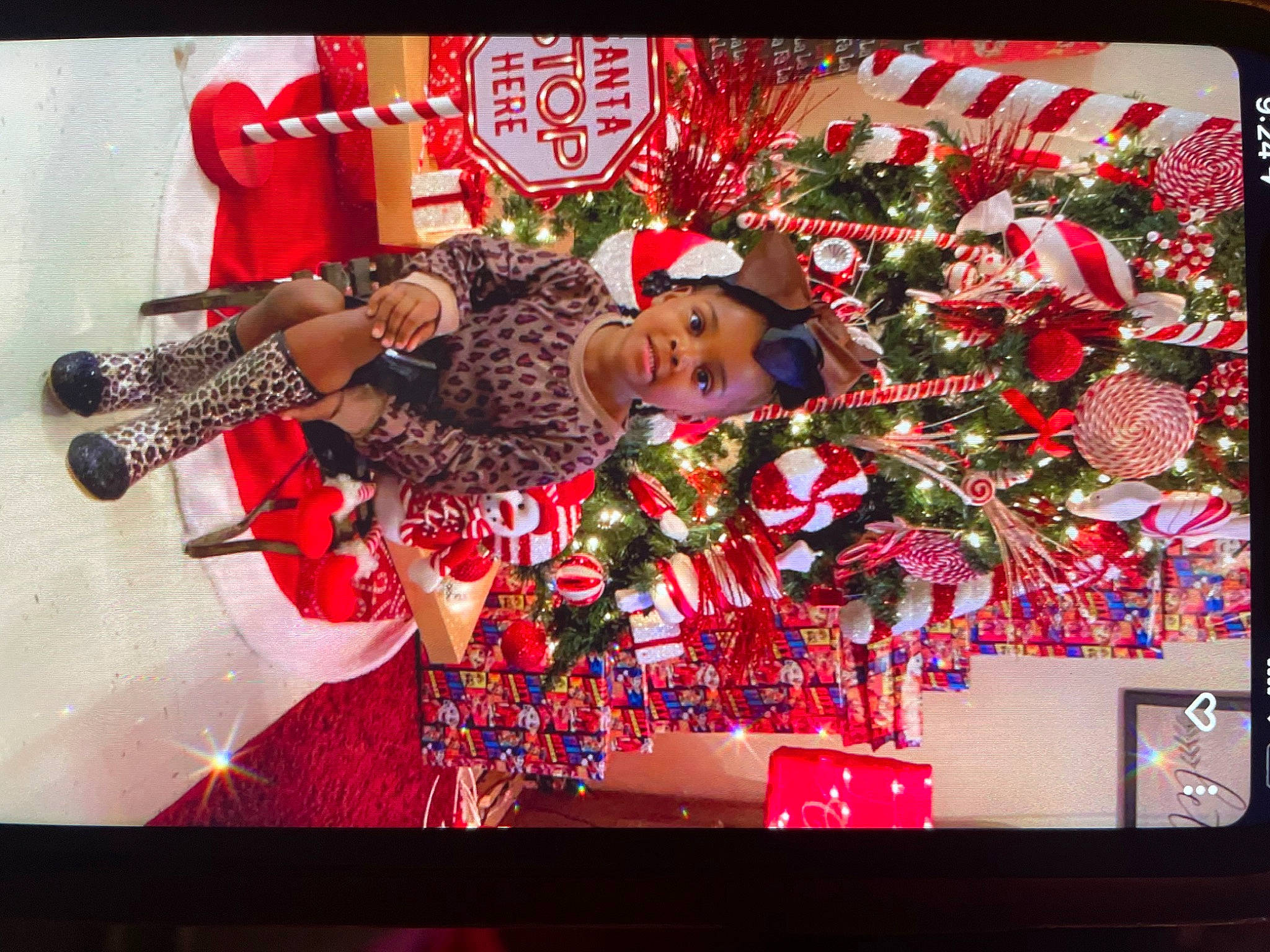 Braylee is registered to the contest to win money with this photo: beauty, christmas_decoration, christmas_ornament, decoration, display_device, event, flat_panel_display, happy, hat, magenta, output_device, pattern, person, pink, plant, rectangle, red, room, television, television_set