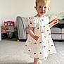 Arabella joined the competition — help win amazing prizes! toddler, child, girl, dress, cherry_pattern, red_bows, barefoot, carpet, living_room, sofa, toy, indoor, portrait, cute, blonde_hair, curly_hair, standing, person, home, young_child