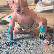 Lyall is registered to the contest to win money with this photo: barefoot, blond_hair, blue_paint, carpet, child, crawling, creative, curious, diaper, face_paint, floor, hand_painted, indoor, messy, pacifier, paint, play, smudged, toddler, toy