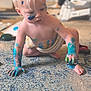 child, toddler, blond_hair, paint, blue_paint, face_paint, messy, carpet, indoor, crawling, barefoot, diaper, pacifier, play, creative, smudged, hand_painted, curious, toy, floor