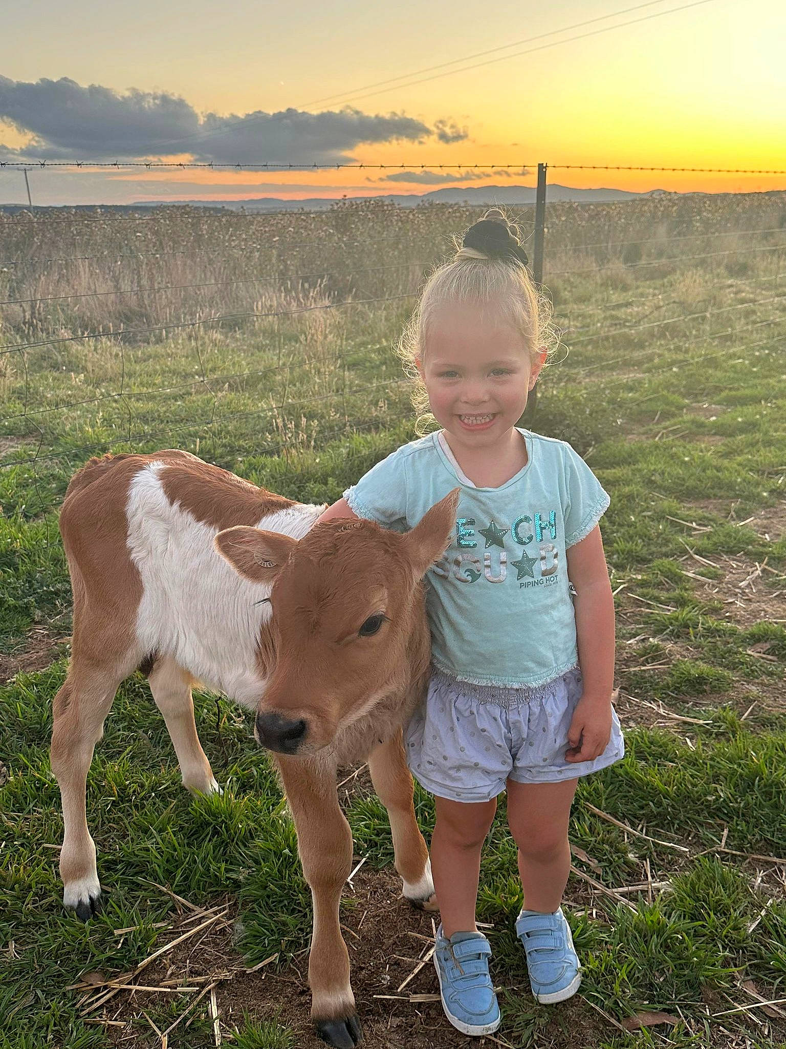 Serayah joined the competition — help win amazing prizes! cloud, fawn, fun, goat, grass, grassland, happy, human_leg, joy, landscape, livestock, meadow, pasture, person, plant, shorts, sky, smile, sunset, terrestrial_animal