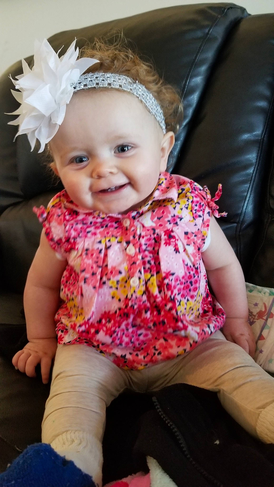 Jacelynn is registered to the contest to win money with this photo: baby, baby_products, baby_toddler_clothing, cheek, child, child_model, dress, fashion_accessory, hair_accessory, head, headband, headgear, joy, pattern, person, pink, product, sitting, skin, smile