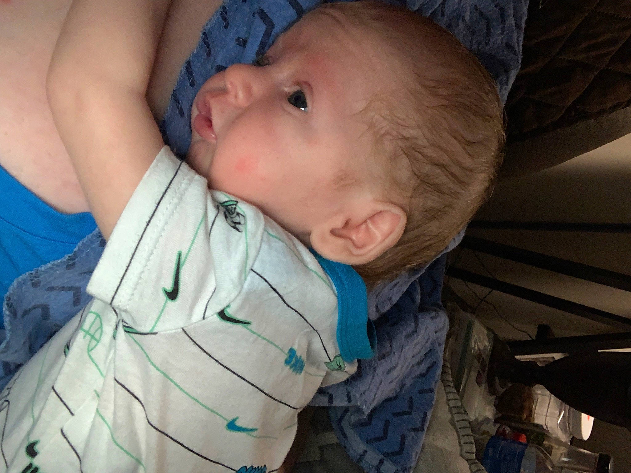 Alex is registered to the contest to win money with this photo: arm, baby, baby_toddler_clothing, blue, cheek, child, comfort, finger, fun, gesture, hand, human_body, iris, mouth, nose, organ, person, skin, smile, thumb