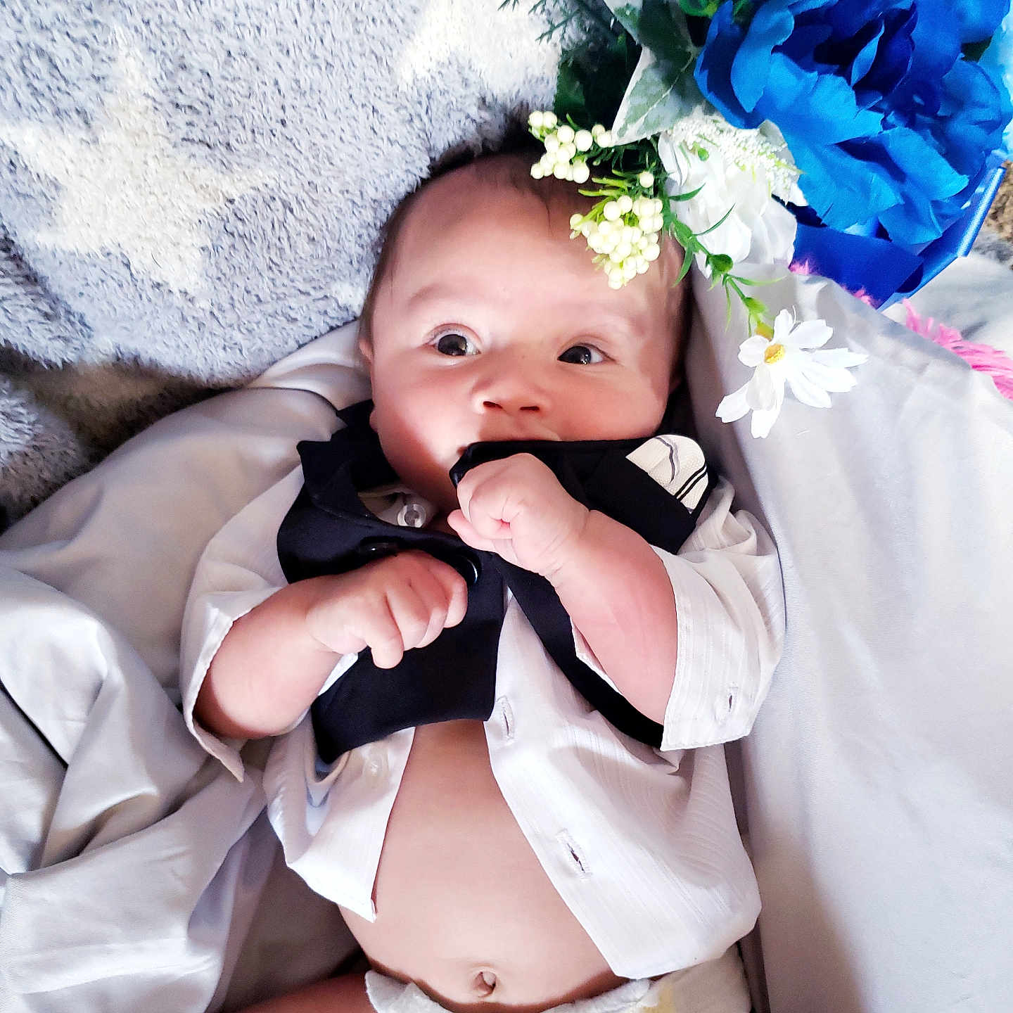 Jacob is registered to the contest to win money with this photo: baby, bodypart, bonnet, clothing, diaper, face, finger, flower, flowerarrangement, flowerbouquet, hand, hat, head, newborn, person, petal, photography, plant, portrait, rose