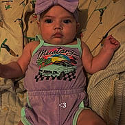 Summer joined the competition — help win amazing prizes! baby, child, infant, purple_bow, romper, mustang, car_graphic, bed, blanket, patterned_sheets, cute, indoors, portrait, lying_down, wide_eyes, headband, clothing, person, skin, small_text_overlay