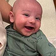 Leonel joined the competition — help win amazing prizes! baby, smiling, infant, face, green_clothing, dinosaur_pattern, happy, cute, child, person, portrait, sitting, hand, skin, head, eyes, mouth, apparel, fabric, indoors