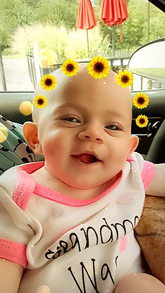 Gracie is registered to the contest to win money with this photo: baby, baby_laughing, baby_products, baby_toddler_clothing, beauty, cheek, child, facial_expression, flower, fun, gesture, happy, head, person, photograph, pink, plant, skin, smile, toddler