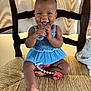 Jocelyn is registered to the contest to win money with this photo: baby, child, smiling, teether, blue_dress, pacifier, chair, woven_chair, curtain, indoors, cute, happy, sitting, toy, infant, skin, hand, foot, expression, portrait